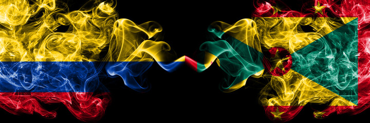 Colombia, Colombian vs Grenada smoky mystic flags placed side by side. Thick colored silky abstract smokes flags.