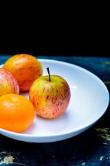 bank dish with tangerine and apples