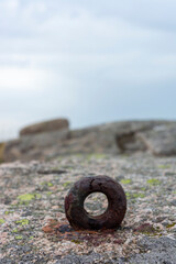 Rusted Metal Loop on the Rocks