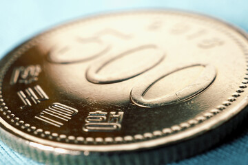 Translation: Bank of Korea. 500 won coin close-up. Bright tinted illustration about money, banking,...