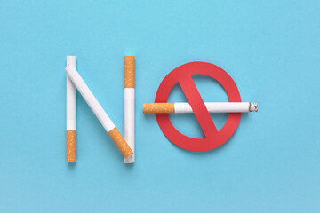 No smoking icon. Red forbidden sign with a cigarette and the Text no smoking on blue background.
