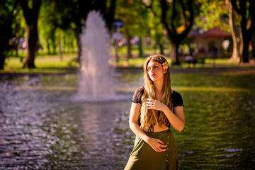 Young blond woman posing sensual on a pond