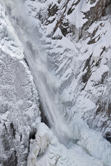 Fototapeta na wymiar Winter landscape of Bear Creek Falls framed by snow and captured with motion blur, San Juan Mountains, Ouray, Colorado, USA