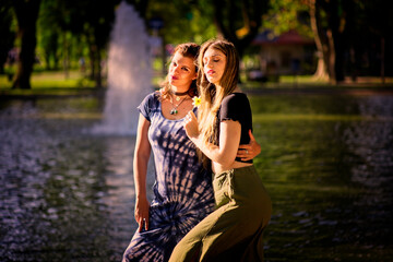 Couple of women posing sensual in a pond