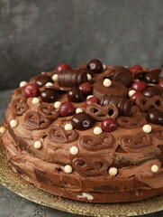 Birthday chocolate cake decorated with chocolates and cherries