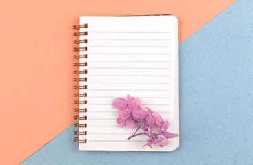 Elegant notebook mockup, blank white paper with dried flowers and with copy space, top view, concept of femenine workspace