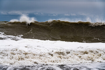 sea waves during a storm on a blue sky