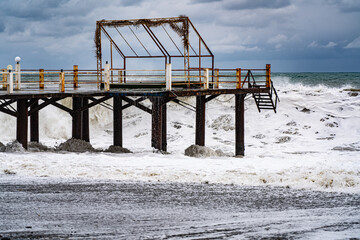 pier against the backdrop of a storm and cloudy sky