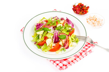 Plate with lettuce, tomatoes, olive oil. Vegetarian menu.