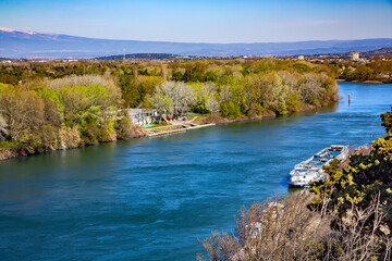 Fototapeta premium Aerial panoramic view of the Rhone river with a large pleasure boat near the pier in Avignon Provence, Southern France.