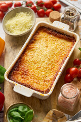 Tasty traditional italian lasagna with bolognese, melted and cheese. Served with ingredients