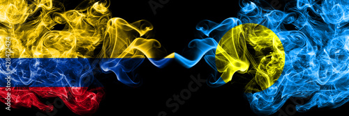 Colombia, Colombian vs Palau smoky mystic flags placed side by side. Thick colored silky abstract smokes flags.