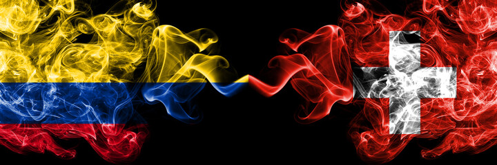 Colombia, Colombian vs Switzerland, Swiss smoky mystic flags placed side by side. Thick colored silky abstract smokes flags.