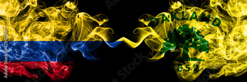 Colombia, Colombian vs United States of America, America, US, USA, American, Oakland, California smoky mystic flags placed side by side. Thick colored silky abstract smokes flags.