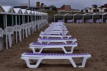 Sun loungers and beach tents without people during coronavirus.