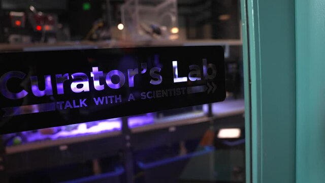 This panning video shows a scientific biology study lab sign that reads "Curator's Lab".
