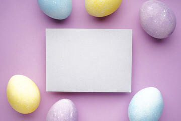 Easter eggs on a purple background, place for text. Flat lay.