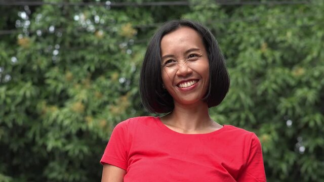 Happy Flirty Indonesian Woman In Red Shirt