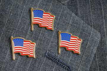 Three flag pins on a suit lapel