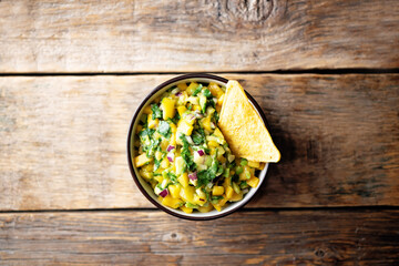 Mango Guacamole with corn chips and ingredients to prepare it