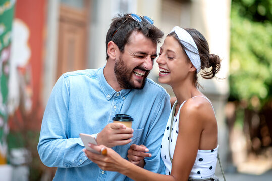 Happy couple using phone