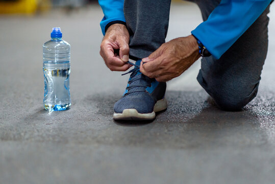 Senior Man Tying Shoelace Outdoors