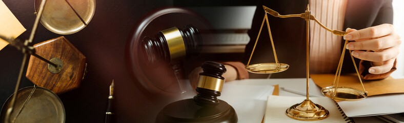 Justice and law concept.Male judge in a courtroom with the gavel, working with, computer and...