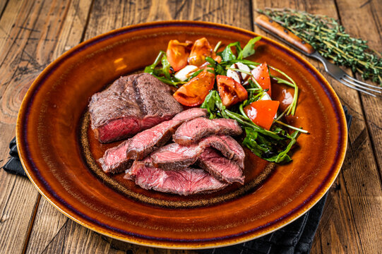 BBq Roasted Oyster Top Blade Or Flat Iron Roast Beef Meat Steak On A Plate With Salad. Wooden Background. Top View