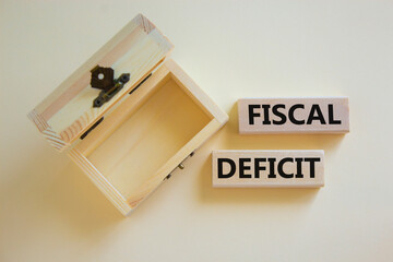 Fiscal deficit symbol. Concept words 'fiscal deficit' on blocks on a beautiful white background, small empthy chest. Business and fiscal deficit concept, copy space.