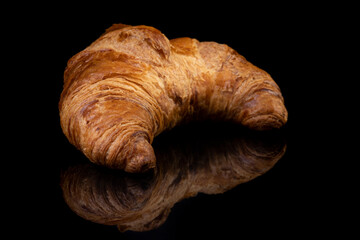 Croissant on black reflective studio background. Isolated black shiny mirror mirrored background for every concept..