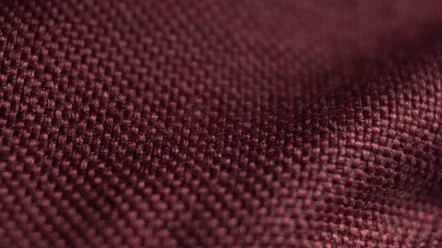 Textile background - burgundy polyester fabric. Slider macro