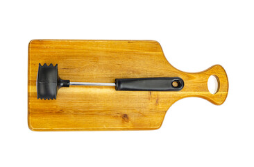Kitchen hammer for meat on wooden cutting board.
