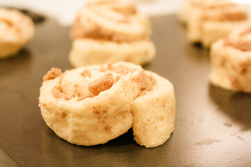 Delicious uncooked cinnamon roll on a pan waiting to be cooked
