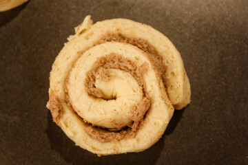 Delicious uncooked cinnamon roll on a pan waiting to be cooked