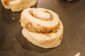 Delicious uncooked cinnamon roll on a pan waiting to be cooked