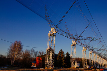Antenna Array. A long row of radio telescopic antennas at the sunset