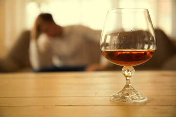 glass of cognac. Alcohol. Man sofa. Problem. 