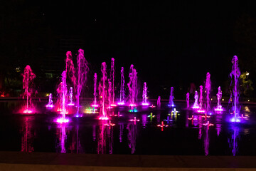 Bright colourful fountain against a dark sky