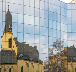 Close-up reflections in modern glass facade in Prague, Czech Republic.