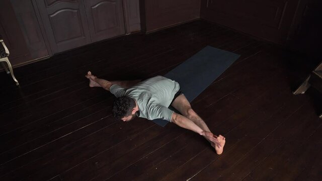 Man Is Training Yoga Asanas. Stretching At Home