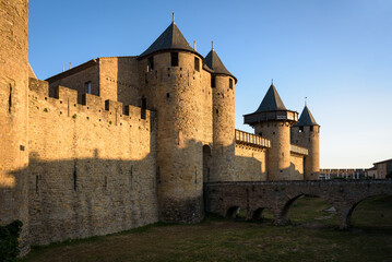 Fototapeta na wymiar Dawn light illuminates the medieval castle walls located within the fortified city of Carcassonne, UNESCO World Heritage Site, France