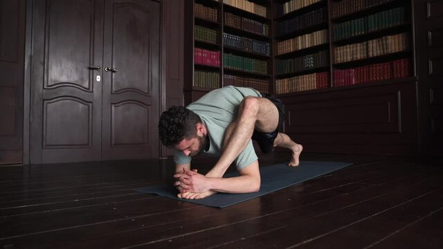 Man Practice Yoga Pose At Home. Attractive Man Making Yoga Pose. Guy Doing Stretching