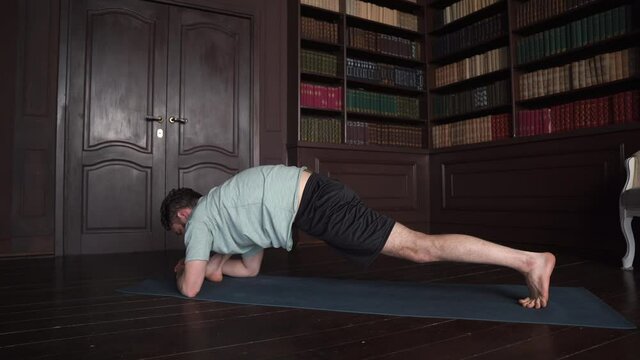 Man Practice Yoga Pose At Home. Attractive Man Making Yoga Pose