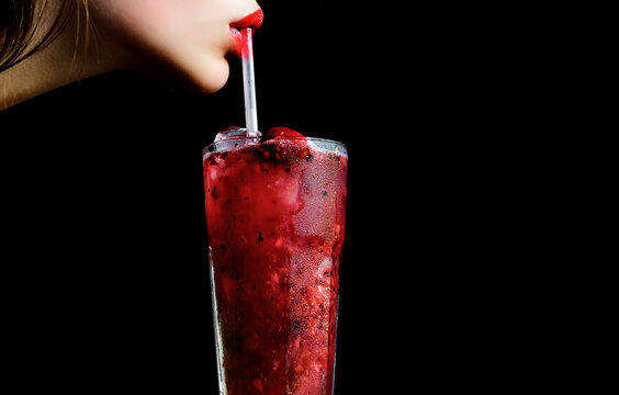 Sensual lips and summer cocktail with strawberry for young girl isolated on black. Thirst and refresh. woman drink cocktail with ice cube, copy space.