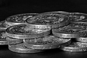 Black and white photo of two pound coins - stock photo