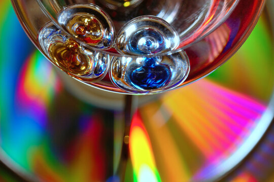 Galileo temperature light bulb on a cd disk with wonderful colours - stock photo