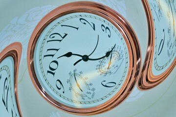 Twirling of a copper coloured clock - stock photo