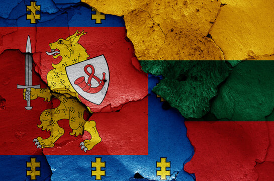 flags of Taurage County and Lithuania painted on cracked wall