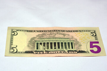 treverse side of 5 dollars portrait, five American dollars banknote background, selective focus,...
