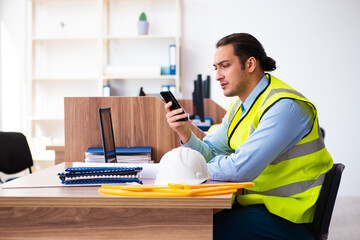 Young male architect working in the office